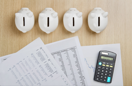 piggy banks with spreadsheets and calculator